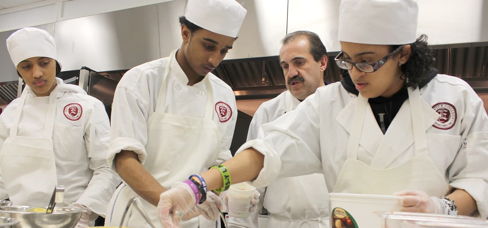 Culinary arts students in professional kitchen